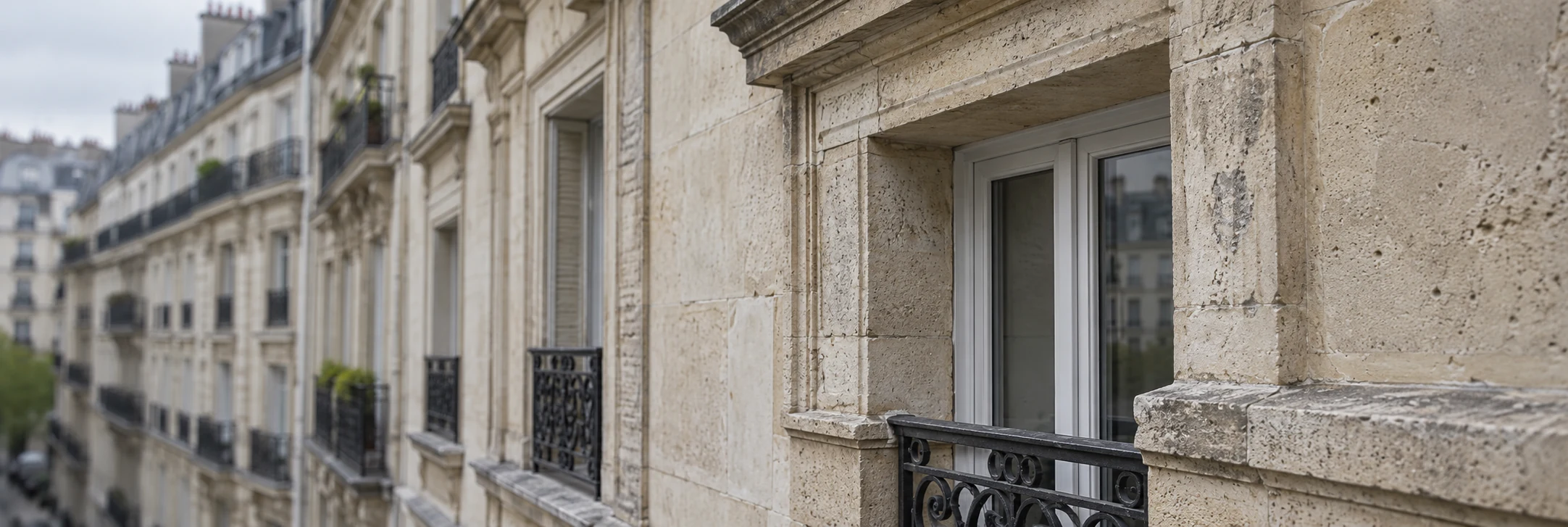 Détail d’un encadrement de fenêtre et d’une façade d’immeuble en pierre de taille